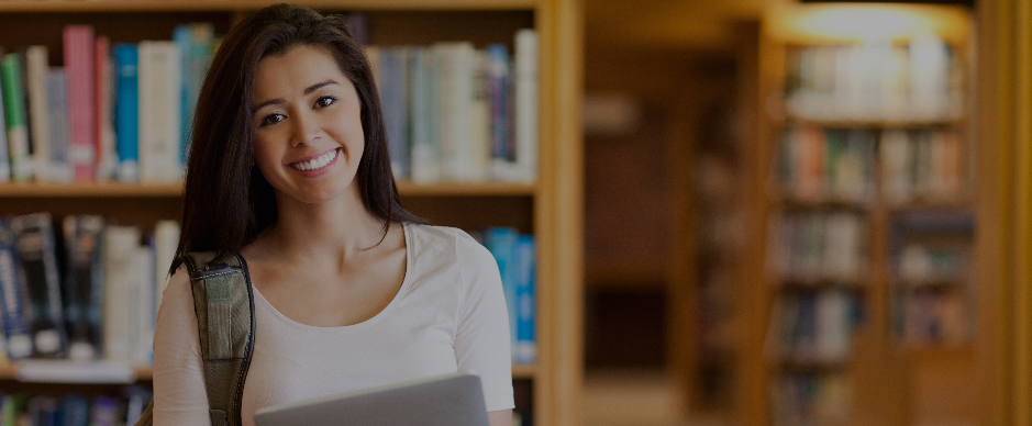 Female student looking and three students sitting in the background